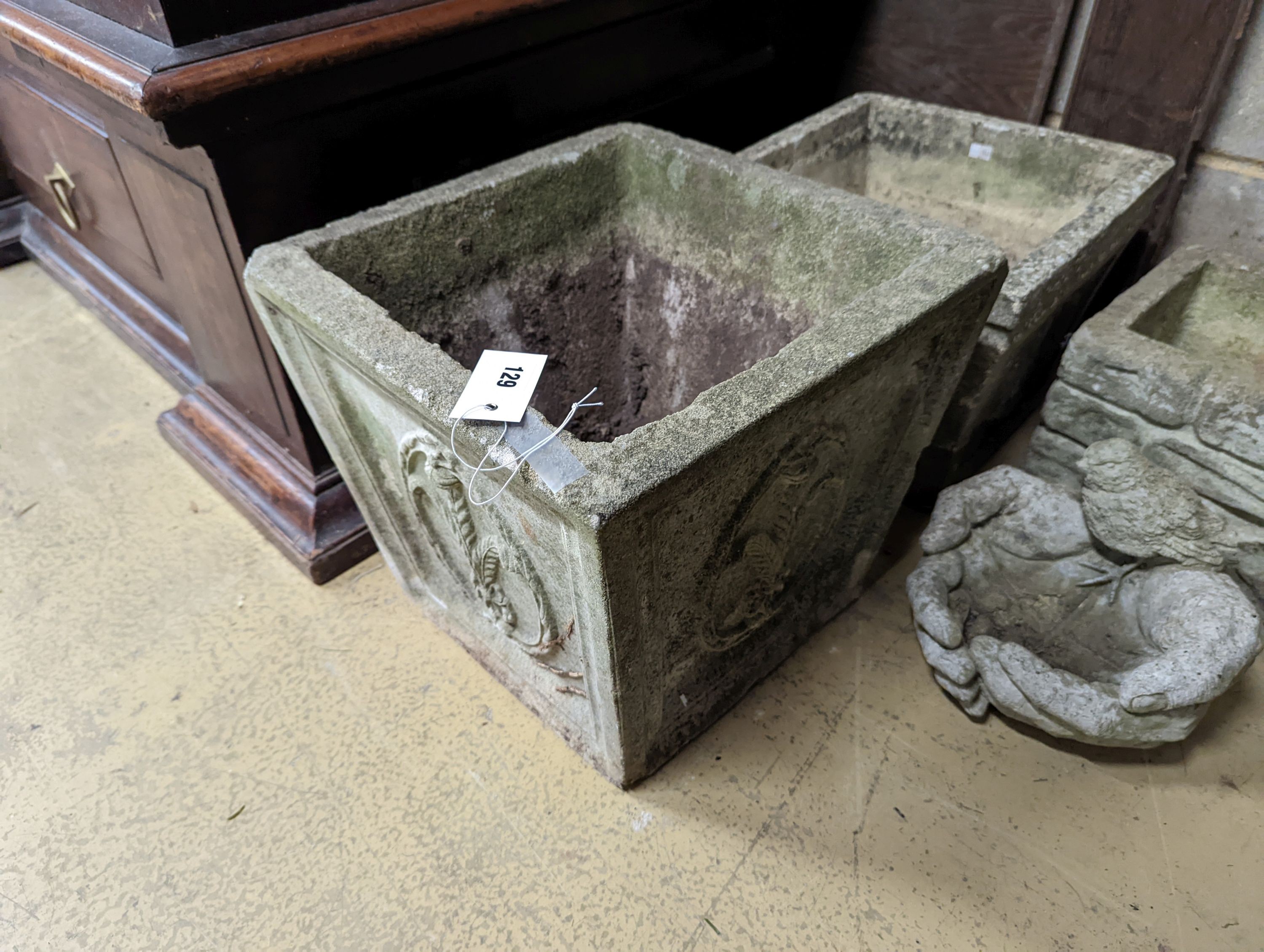 Three square reconstituted stone garden planters together with a bird bath, largest height 32cm